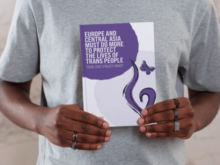 A picture of a Black person holding TGEU's TDoR policy brief.