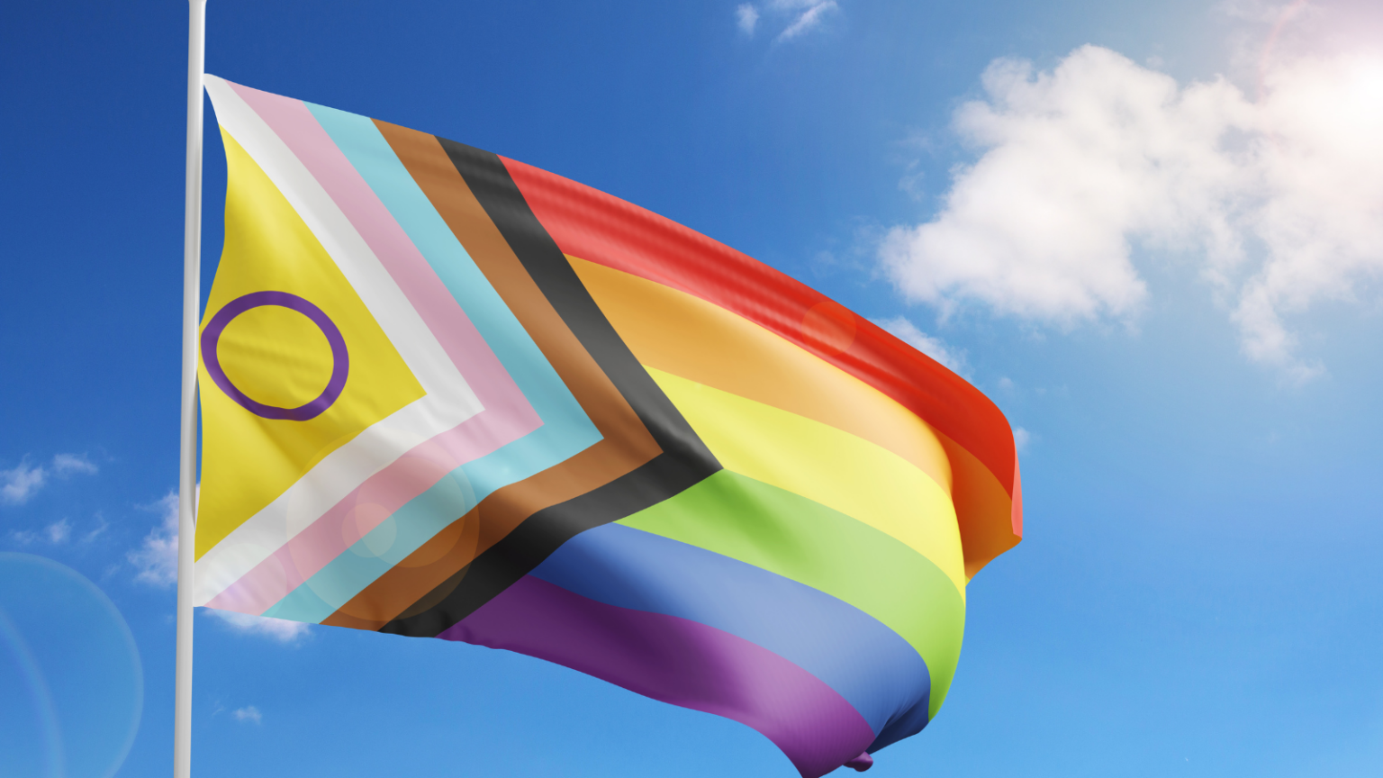 The inclusive pride flag, with elements of the intersex, trans, and rainbow flags, and black and brown stripes.