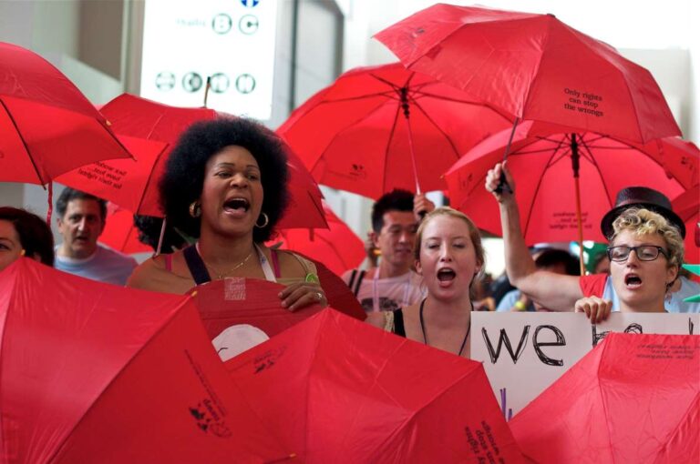 Sex workers marching with red umbrellas