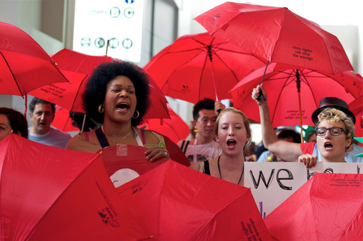 Sex workers marching with red umbrellas