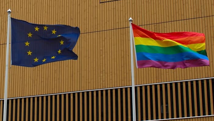 EU flag and Pride flag, waving