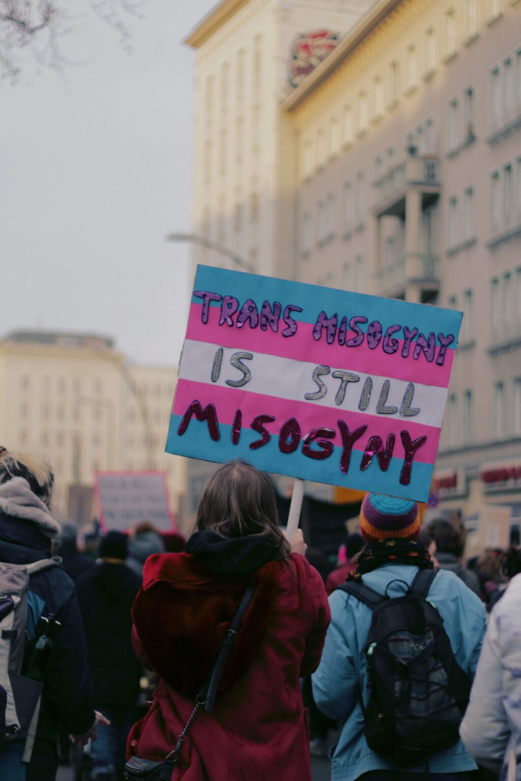 Discrimination against trans women. A protestor holds a sign that says 'trans misogyny is still misogyny'