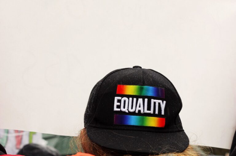 Black cap with the word 'Equality' embroidered between two stripes showcasing nuanced rainbow colors.