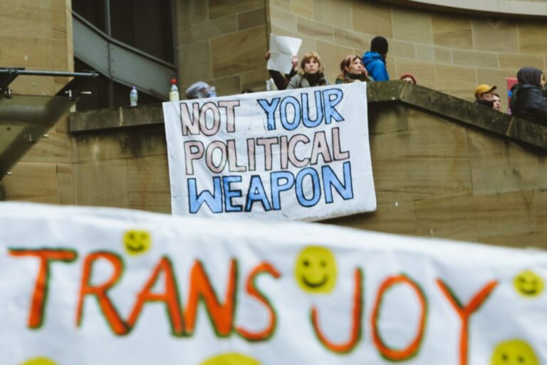 Protesters hold banners saying 'Not your political weapon' and 'Trans joy' - Pic by Thiago Rocha