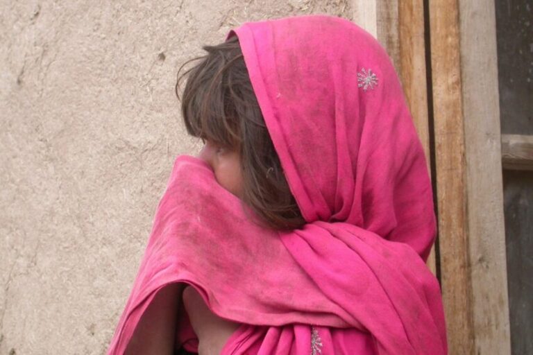 Young Afghan woman wearing a pink veil