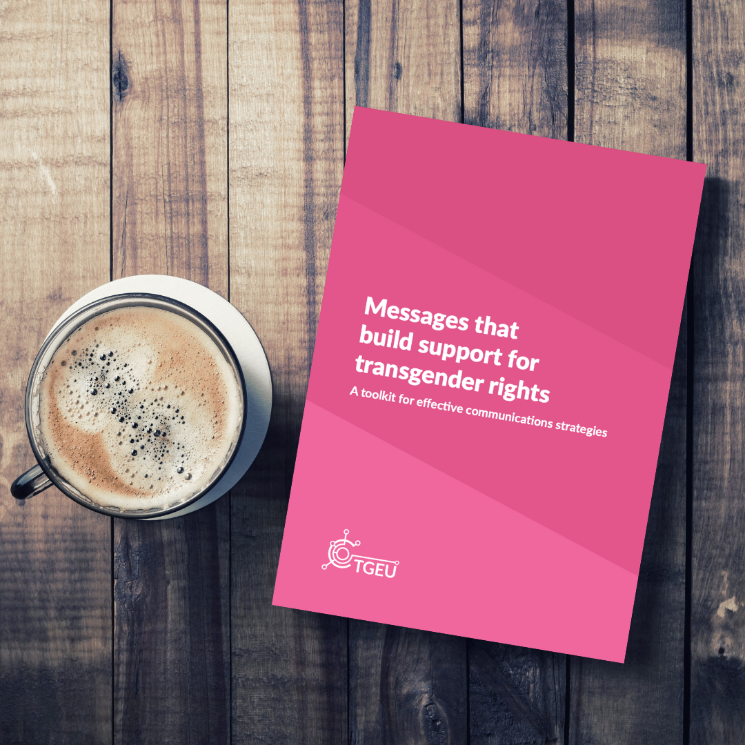 A copy of 'Messages that build support for transgender rights: A toolkit for effective communications strategies' on a table next to a cup of coffee.