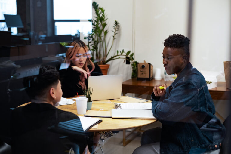 A group of co-workers of varying genders having a meeting