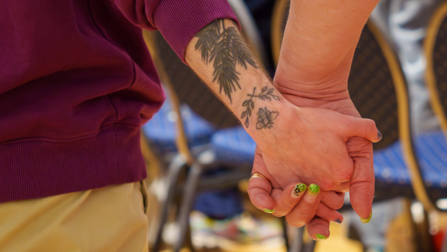two trans people holding hands